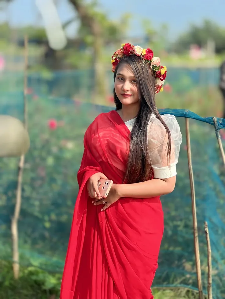 A photorealistic vertical medium portrait of the young South Asian woman from the reference image, faithfully preserving her exact