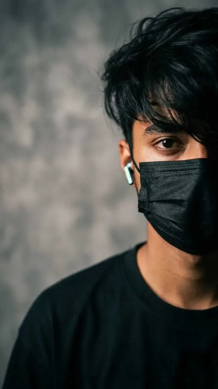 Ultra-realistic cinematic portrait of the same young man from the reference image, preserving 100% facial identity, facial features,