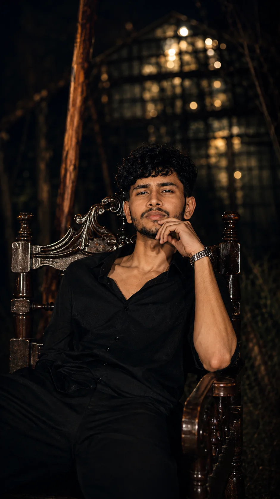 Ultra-realistic 8K DSLR-quality cinematic night portrait of a young man seated confidently on an ornate vintage carved wooden armchair