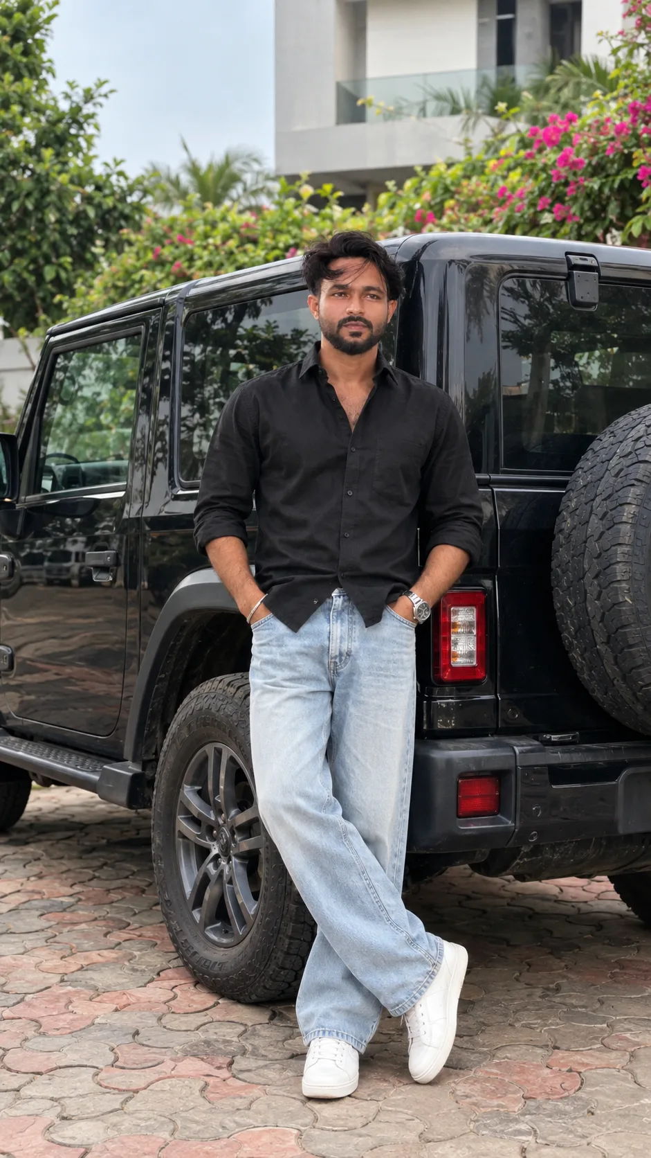 Create a photorealistic, high-end cinematic full-body fashion photograph of a stylish young South Asian man standing confidently beside a