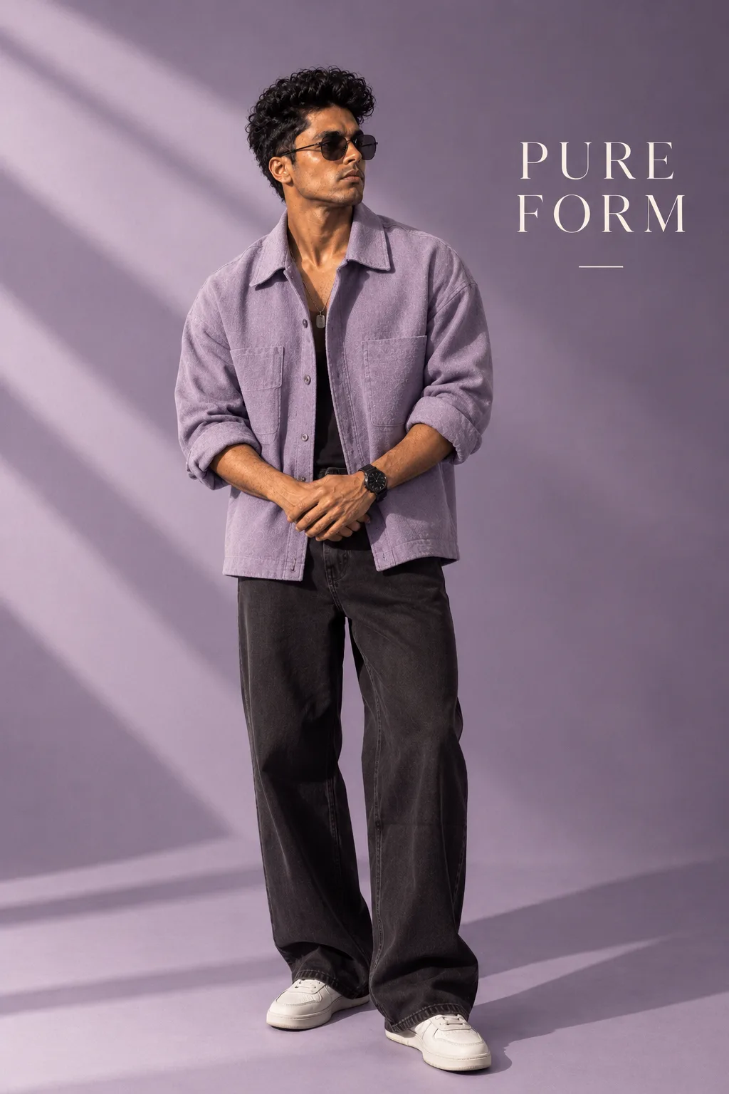 Luxury editorial campaign.Main Subject: Male model wearing an oversized lavender overshirt.Pose: Hands loosely joined in front.Camera: