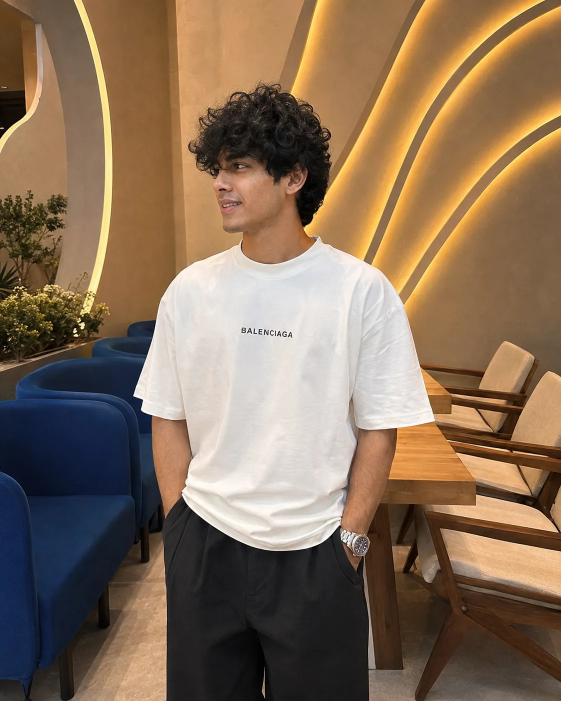 Create an ultra-realistic, high-end full-body indoor fashion photograph of a young adult male, closely matching the provided reference