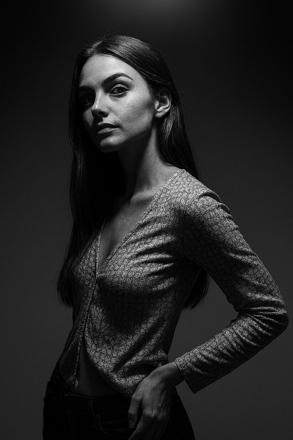 Create a high-resolution, cinematic black-and-white side portrait using my real unedited face from the original image, under a dramatic