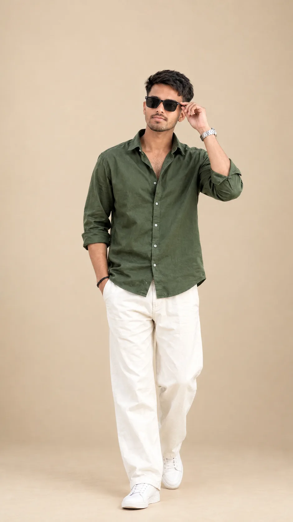 Create a highly realistic full-body fashion portrait of a stylish young South Asian/Indian man standing confidently in a minimal warm beige