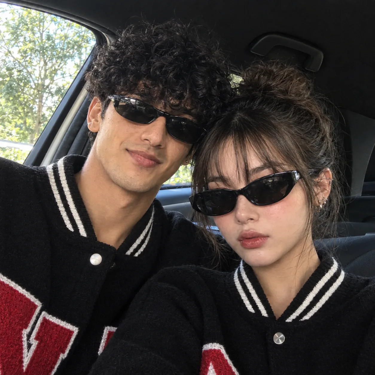 Ultra-realistic candid couple selfie inside a modern car, using the uploaded reference image as the exact identity reference for both