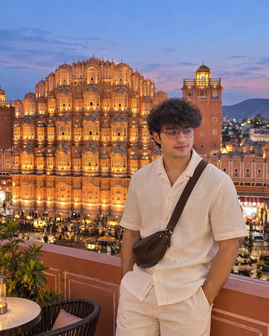 Create a photorealistic vertical travel photograph of a young adult man standing on a rooftop terrace in Jaipur, Rajasthan, with the