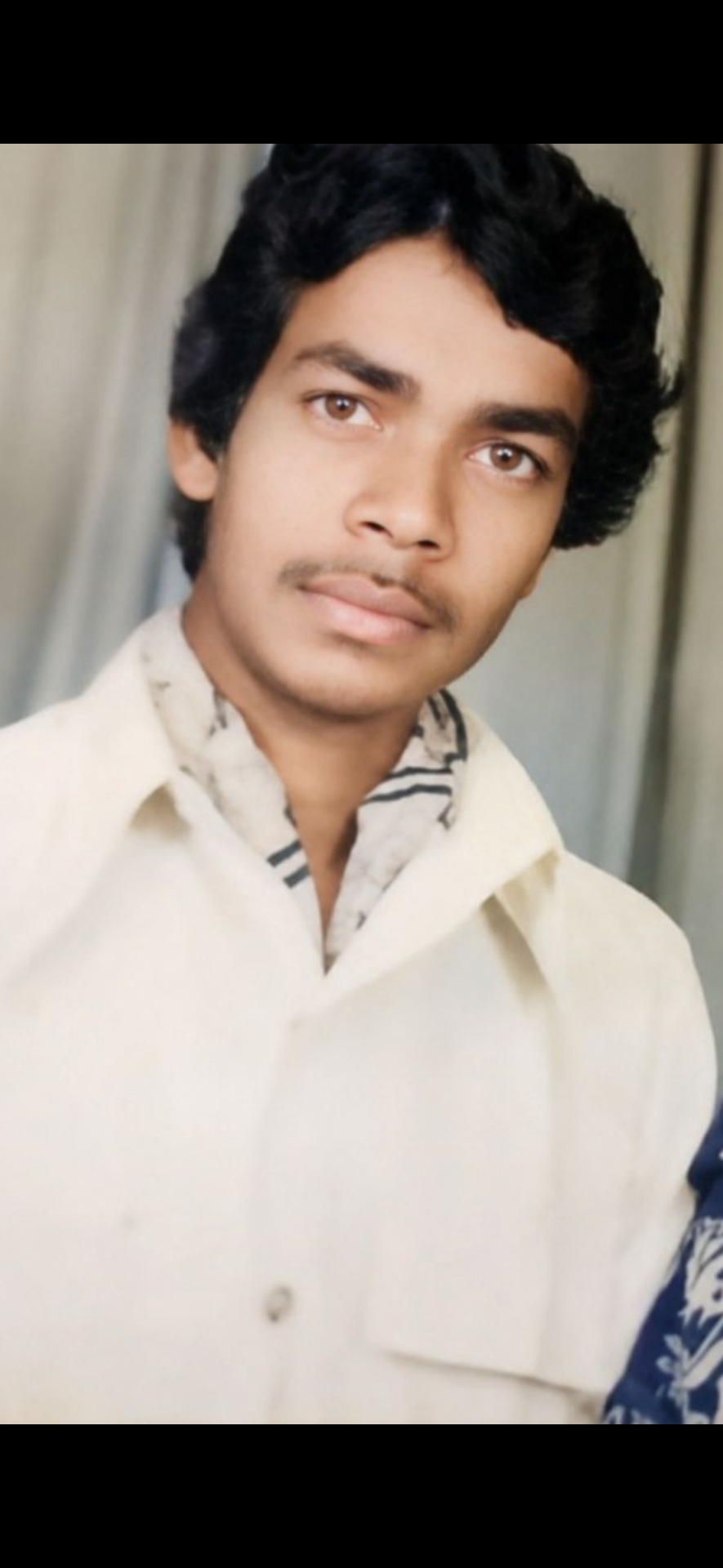 Create an ultra-realistic vertical 9:16 portrait that looks like an authentic Indian photograph shot and printed in the 1980s.