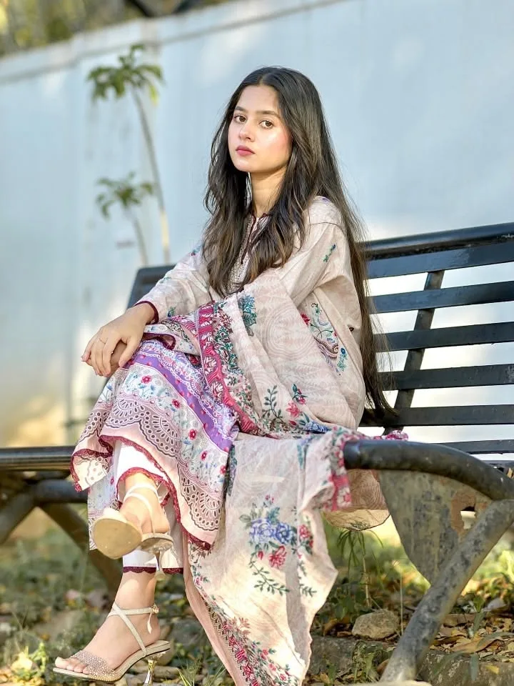 A photorealistic vertical portrait of the young South Asian woman from the reference image, faithfully preserving her exact facial