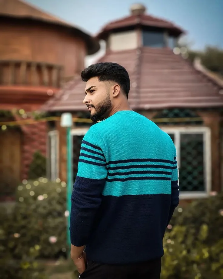 Candid Outdoor Profile Portrait of Young Indian Man in Knitted Sweater