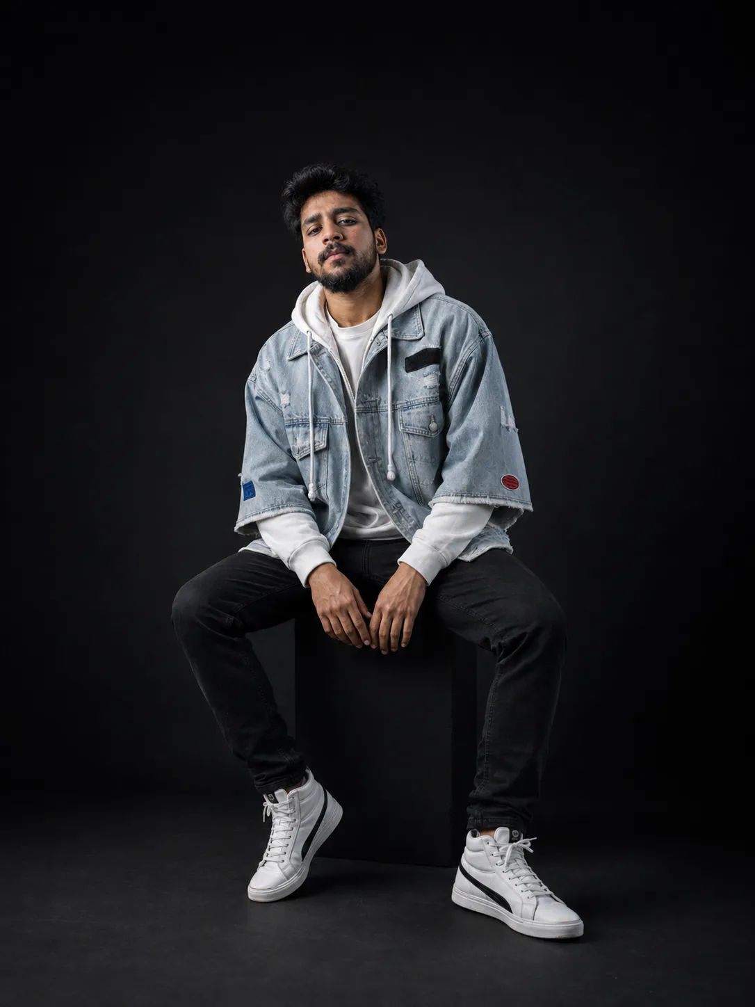 Create a premium, ultra-realistic full-body studio streetwear editorial portrait of the uploaded man, preserving his natural facial