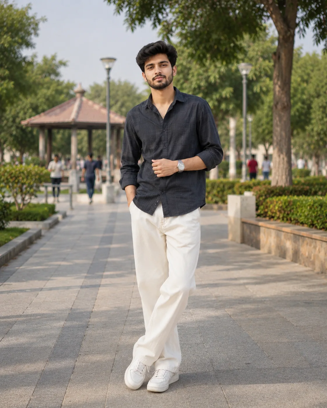 Create a highly realistic, natural-looking full-body outdoor portrait of a stylish young South Asian man with naturally textured dark hair