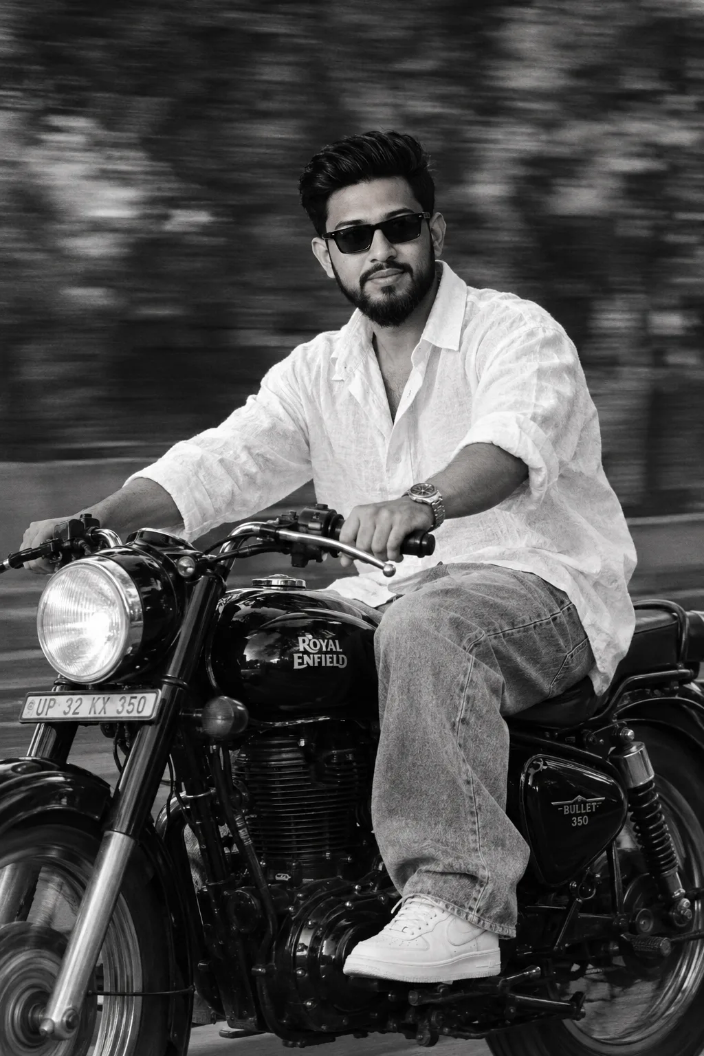 A 5'7" YOUNG MAN WITH A SLIM FIT RIDES HIS BLACK ROYAL ENFIELD BULLET 350 WITH CONFIDENCE GLANCING TO THE SIDE.