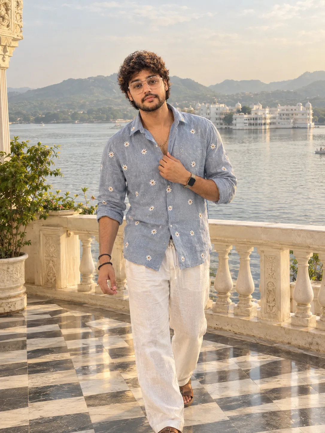 "A bright, elegant travel portrait of a young man with thick, soft black curly hair in a rounded crop, a light stubble beard and mustache,