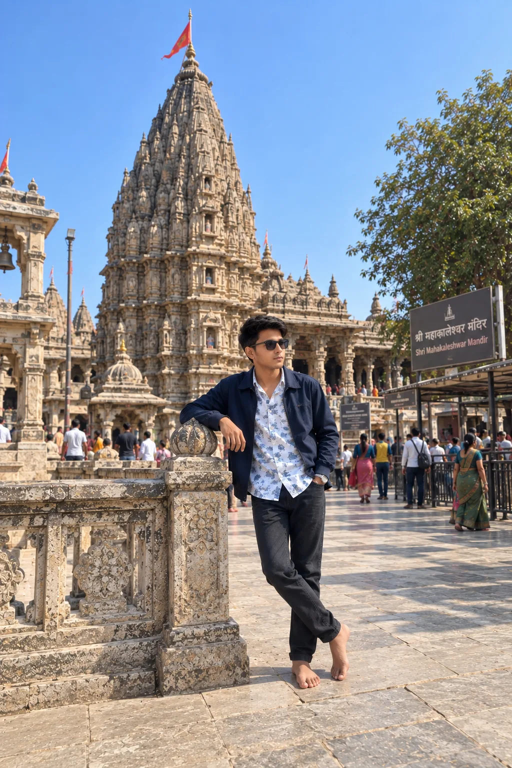 Create a highly realistic, ultra-detailed cinematic travel photograph of a young Indian man casually posing beside a magnificent historic