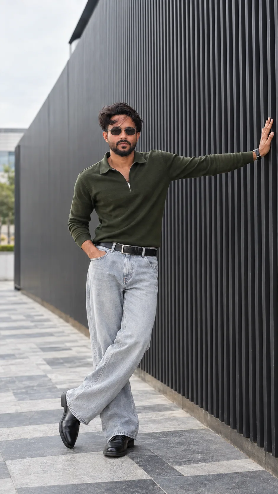 Create a highly realistic, photorealistic cinematic full-body fashion photograph of a young South Asian man posing confidently beside a