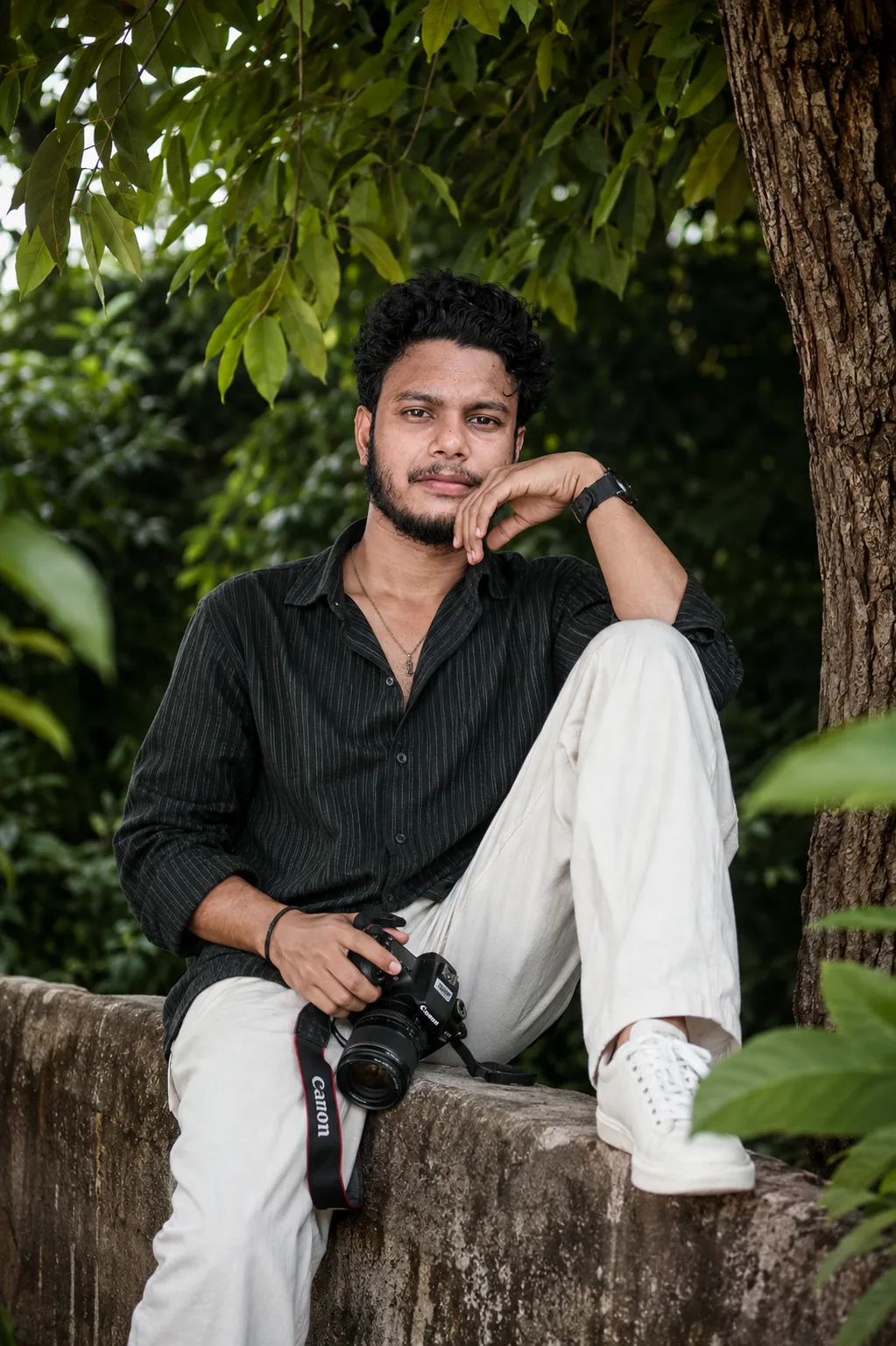 A detailed text prompt to recreate this portrait: A high-resolution, photorealistic portrait of a 26-year-old south Asian man with curly