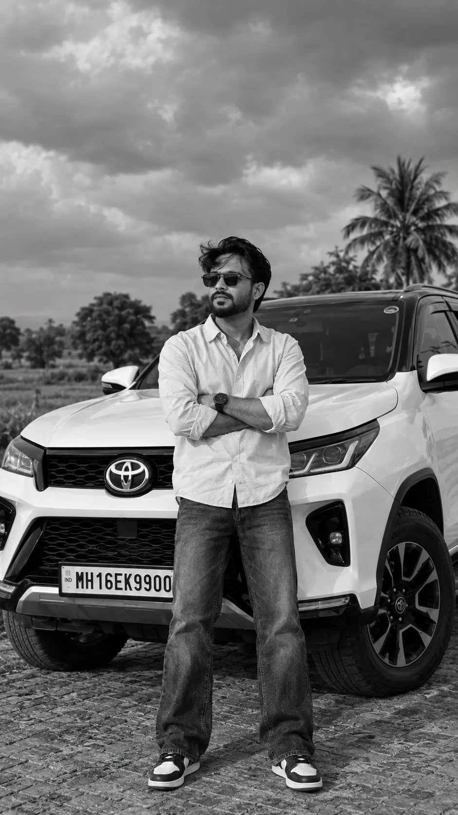 ### 📸 AI Image Prompt Create an ultra-realistic, cinematic black-and-white full-body fashion photograph of the young Indian man from the