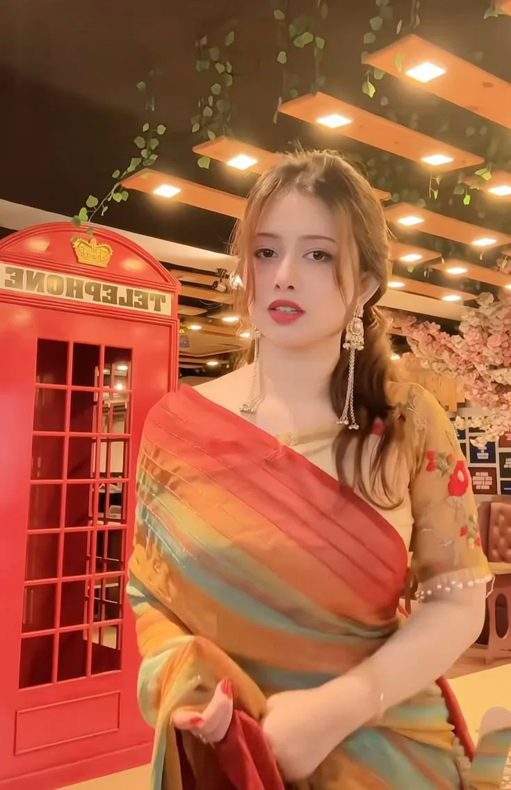 Create a highly detailed, photorealistic full-length portrait of a young Indian woman standing gracefully inside a stylish modern