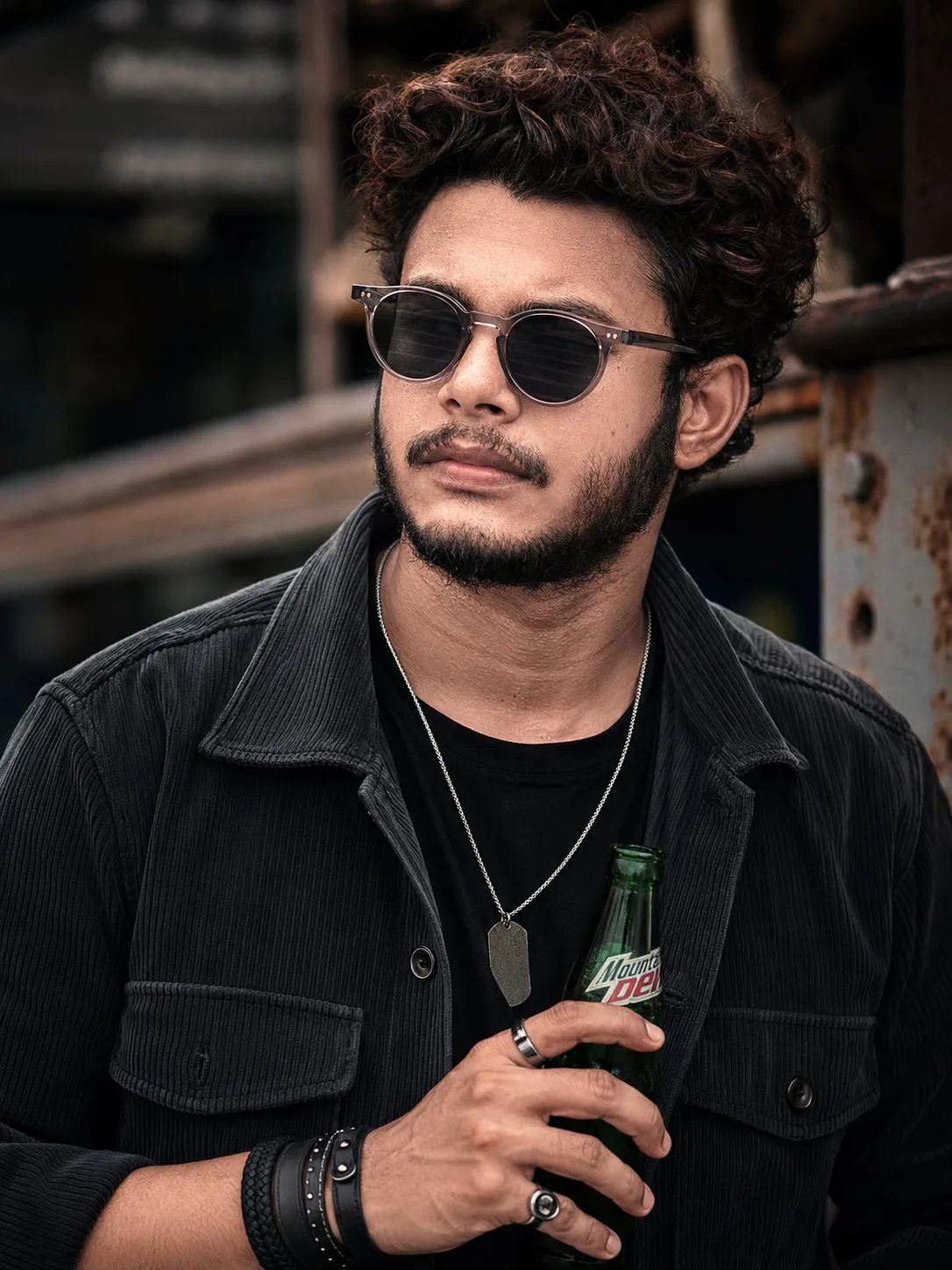 An ultra-realistic cinematic portrait of a stylish young South Asian man with messy textured brown hair and a well-groomed dark beard.