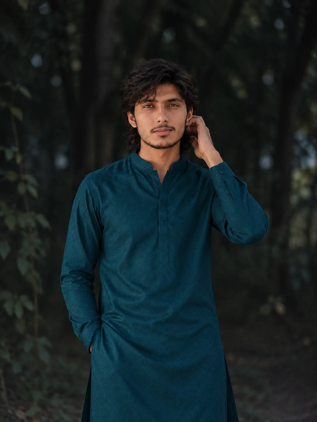 A high-resolution, photorealistic medium-shot portrait of the young man from the reference image, preserving his exact likeness,