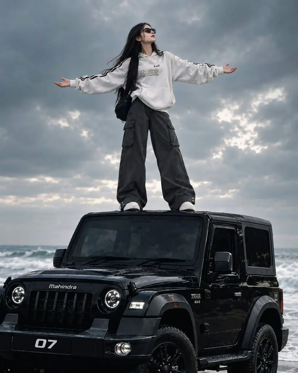 Create an ultra-photorealistic cinematic wide-angle photograph of a young adult woman standing on the roof of a glossy black Mahindra Thar