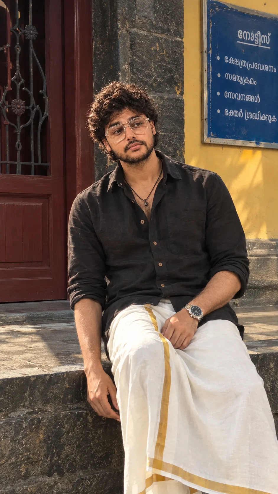 "A stylish, candid full-length lifestyle portrait of a young man with thick, voluminous black wavy-curly hair falling softly around his