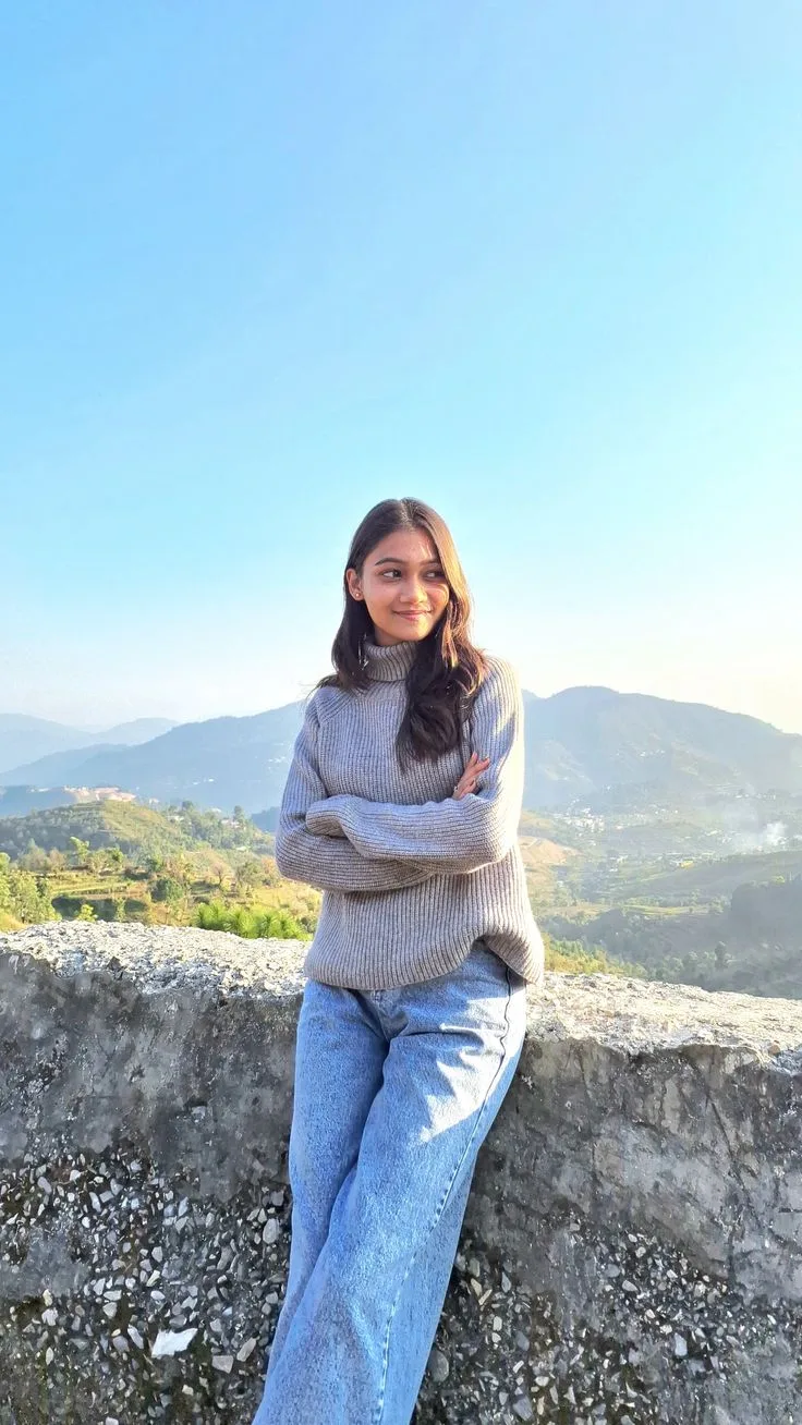 Photorealistic vertical shot of the young South Asian woman from the reference image, preserving her facial identity, soft features, fair