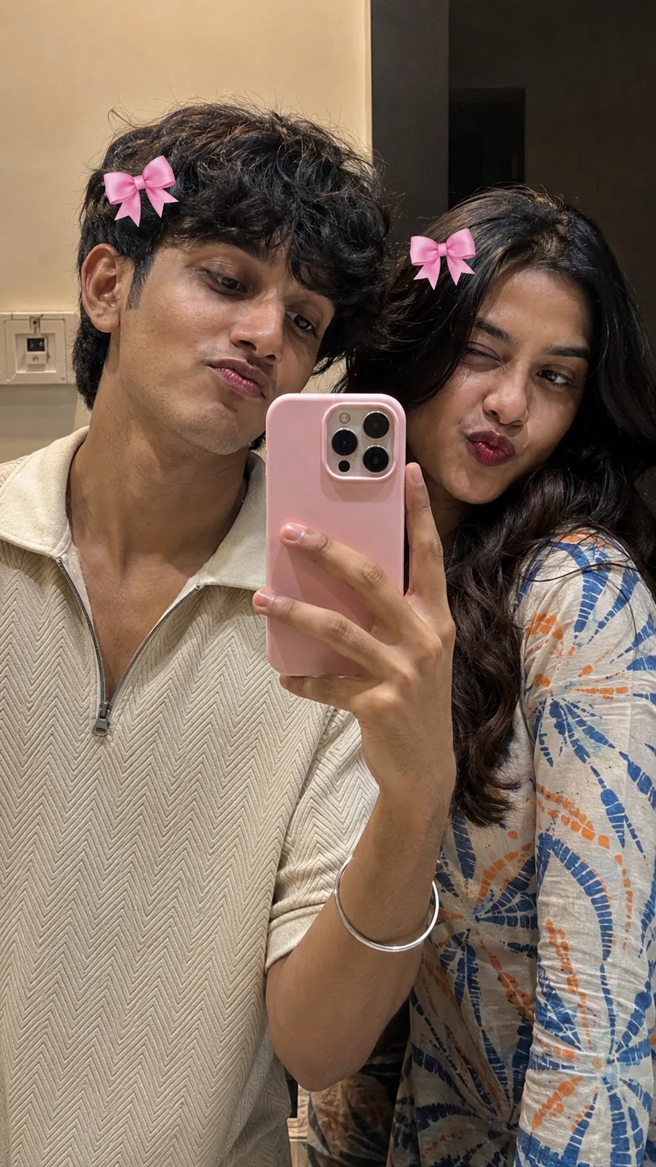 A REALISTIC, HIGH-QUALITY MIRROR SELFIE OF TWO YOUNG SOUTH INDIAN MALE AND FEMALE FRIENDS POSING PLAYFULLY.