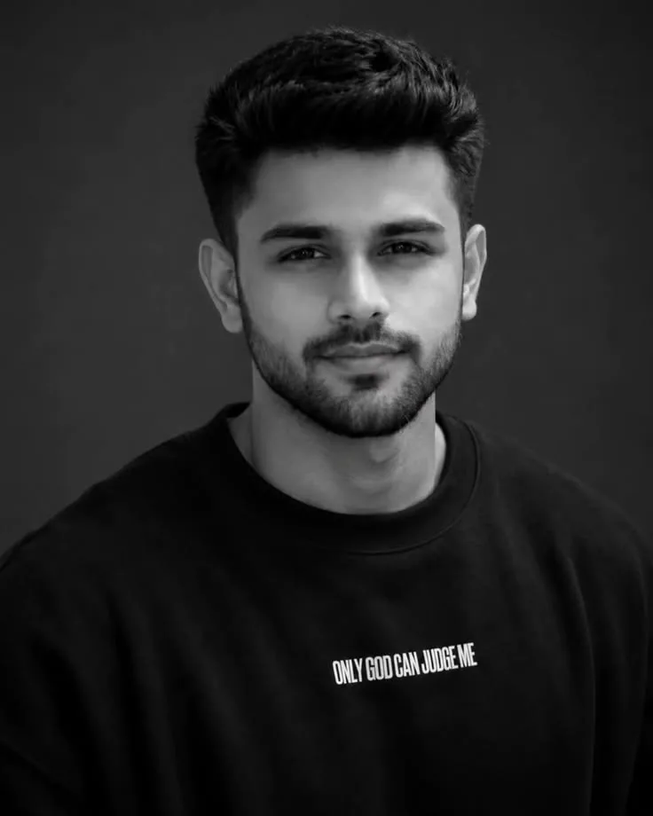 Monochrome Studio Portrait of Young Indian Man in Graphic Sweatshirt