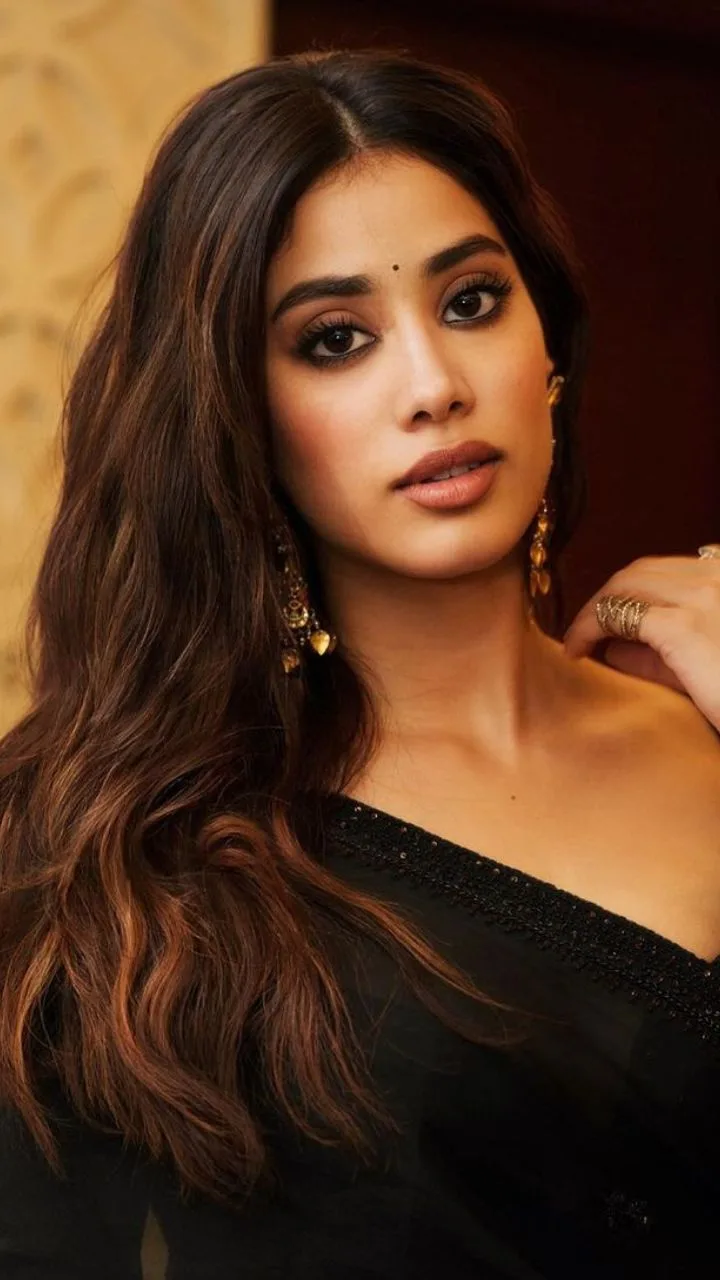 Ultra-realistic cinematic Indian fashion portrait of a young South Asian woman wearing an elegant black saree with a subtle shimmering