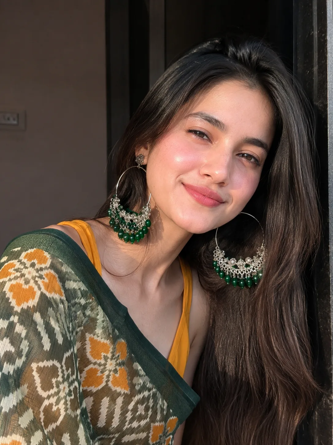 Ultra-realistic high-resolution portrait of a young woman wearing a beautiful traditional saree with a deep forest-green border and
