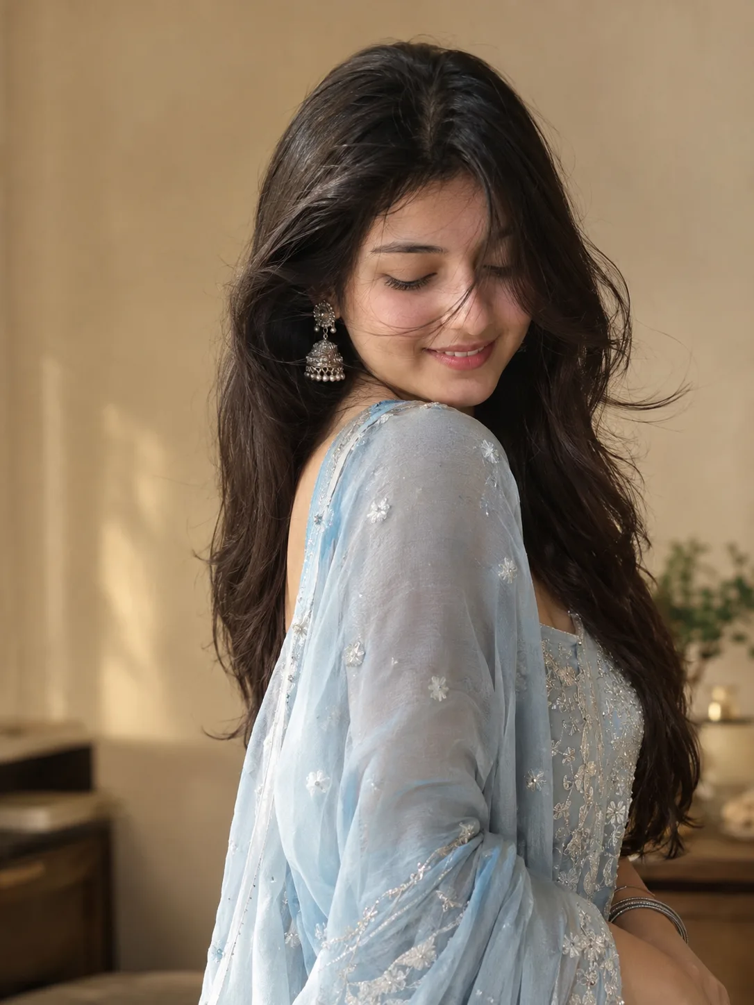 Create a photorealistic portrait of a young South Asian woman in a soft powder-blue embroidered traditional outfit with delicate silver