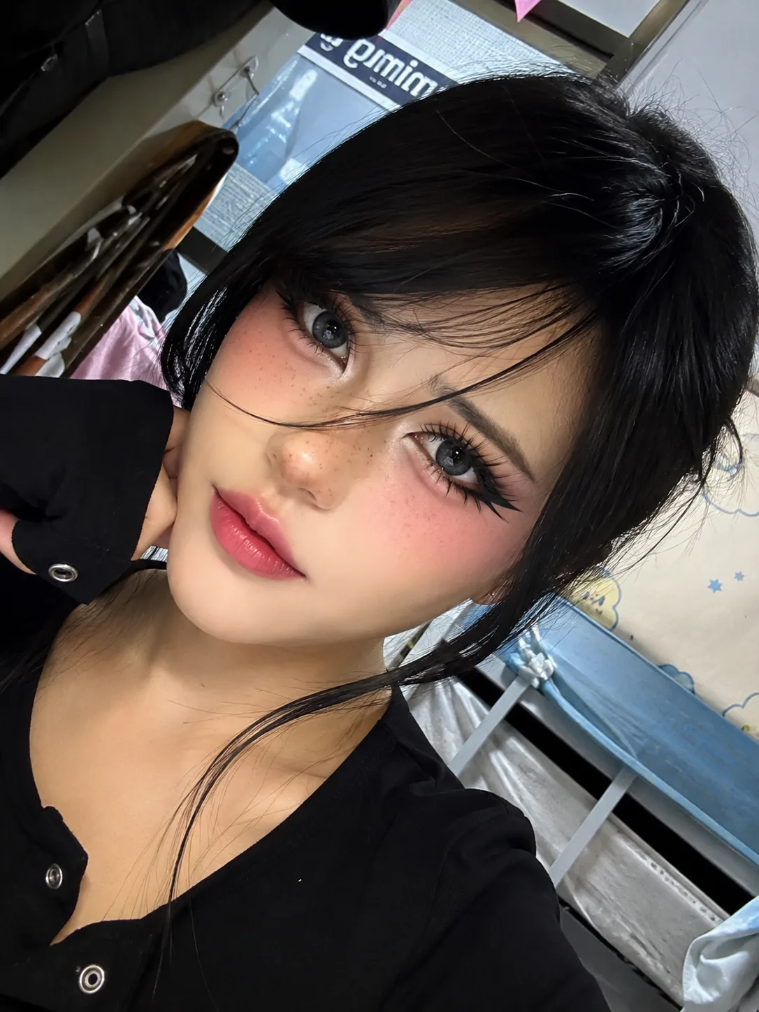 Create an ultra-realistic close-up selfie portrait of a young woman indoors.