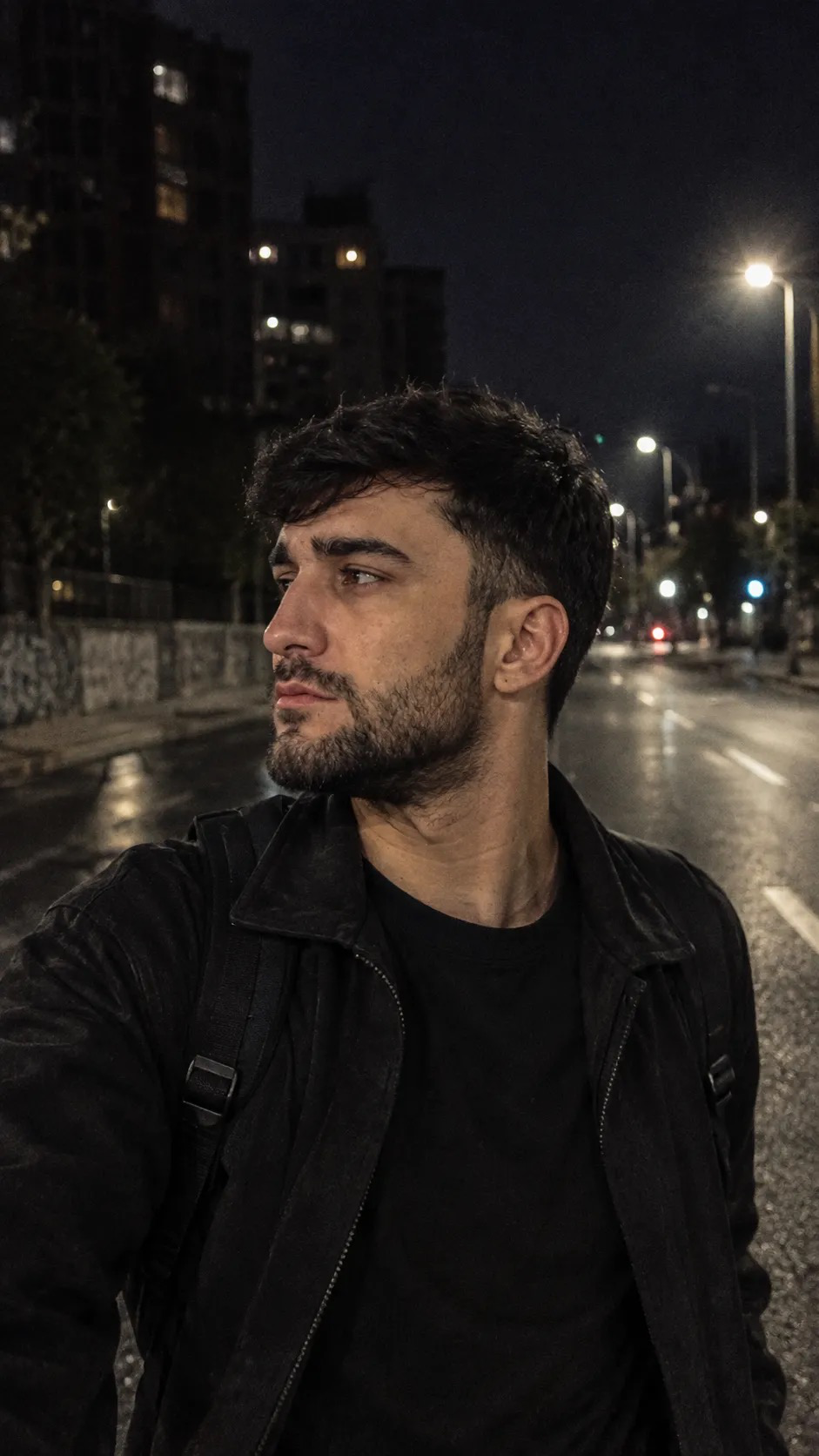 Glooomyboy viral prompt Hyper-realistic vertical (9:16) night street portrait of a young man in profile, captured mid-motion on an empty