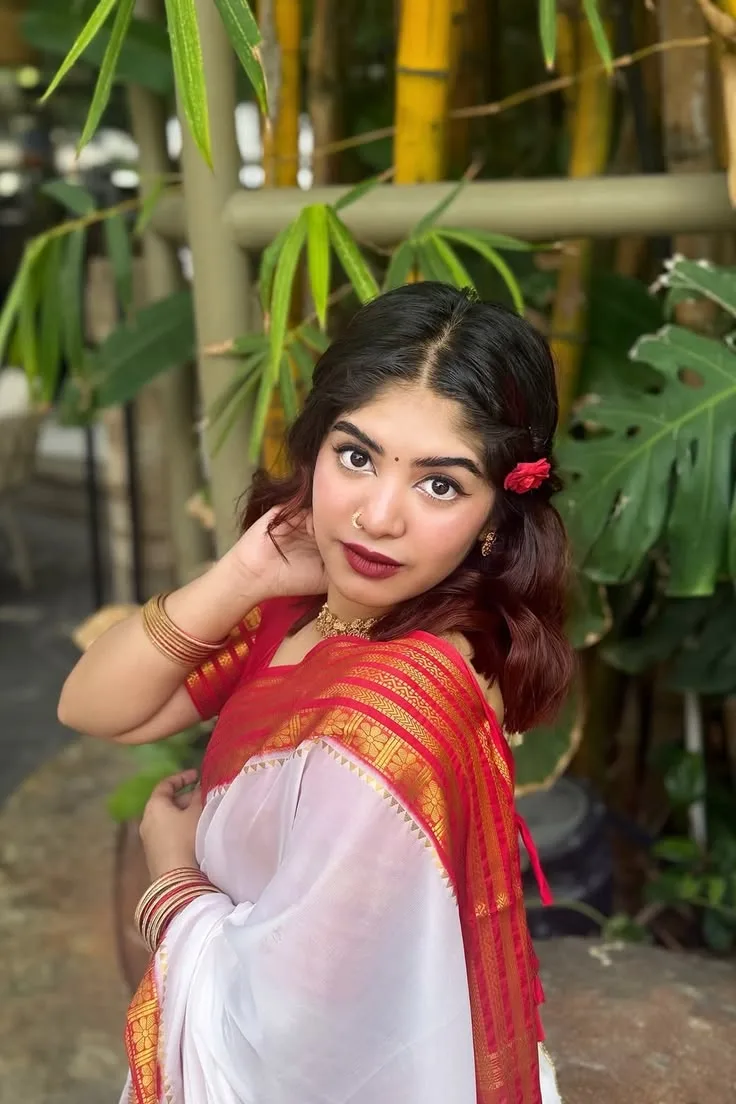 Candid Outdoor Portrait of Indian Woman in Traditional Red-Bordered Saree