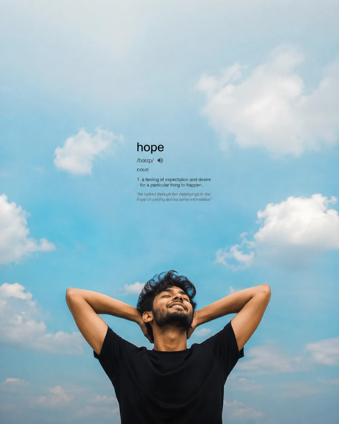 Create a peaceful, minimalist, ultra-realistic cinematic outdoor portrait of a young South Indian man standing beneath an enormous open