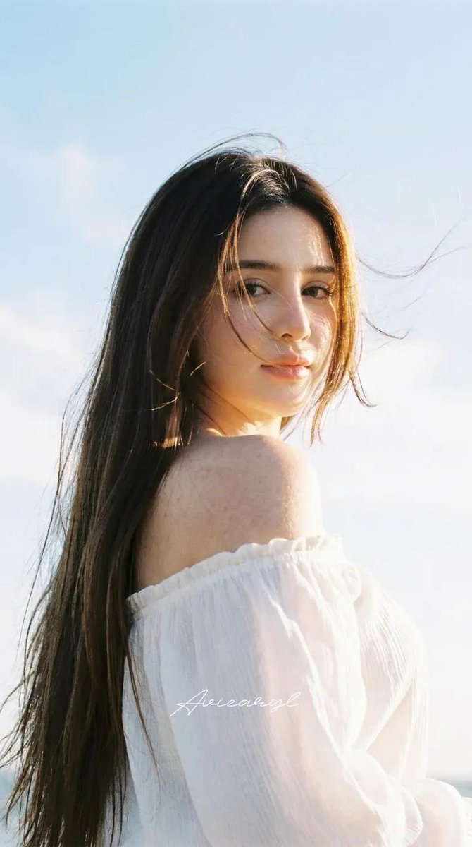 HAIRSTYLE: Ultra-long, sleek dark-brown hair with subtle warm, sun-kissed highlights.