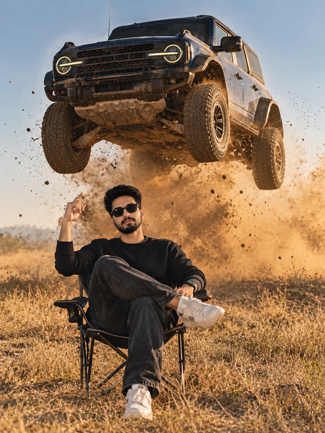Create an ultra-realistic cinematic 3:4 vertical photo of a person sitting confidently on a small folding camping chair in a dry grassy